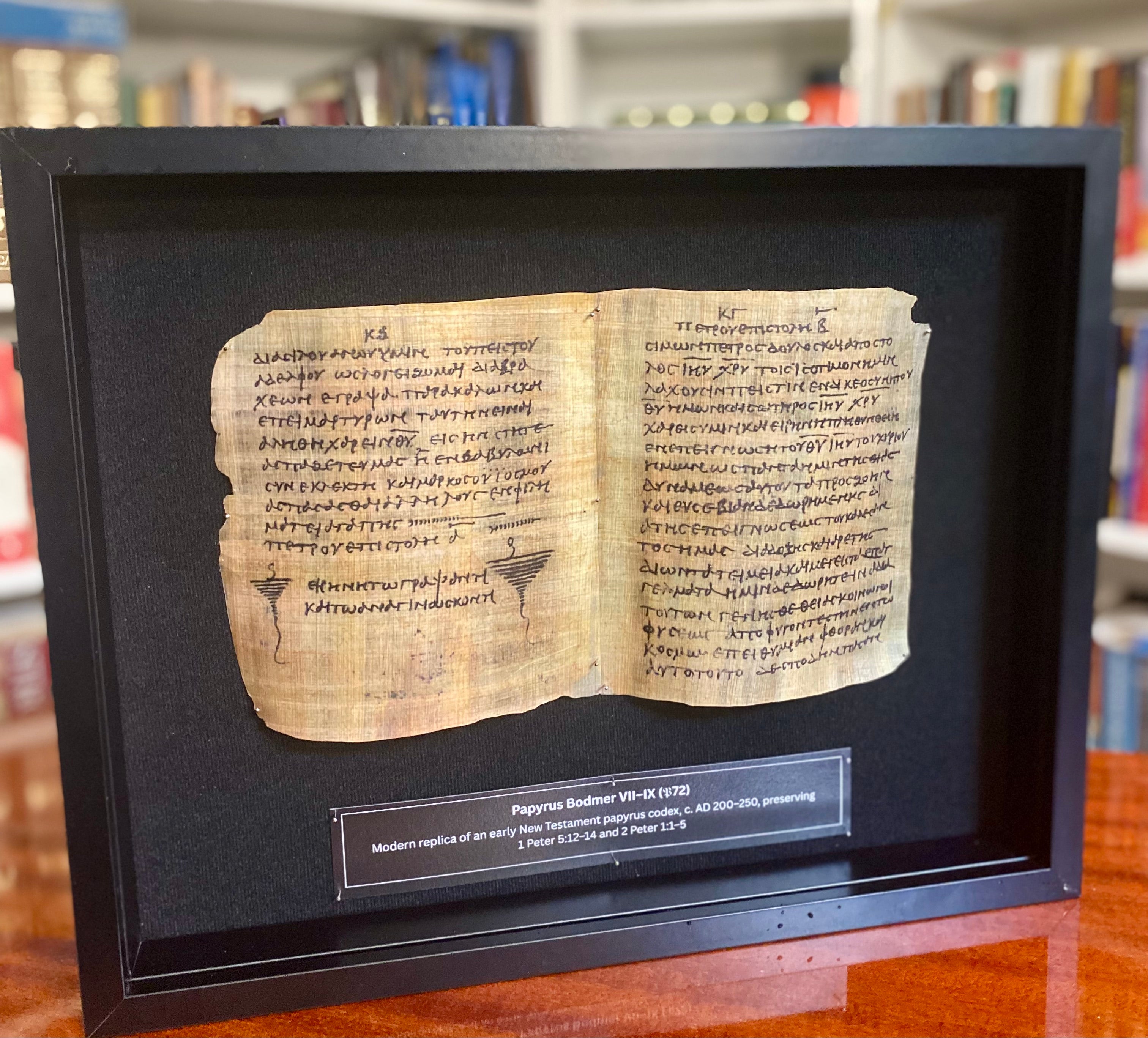 Framed replica of Papyrus 72, facing pages of 1 and 2 Peter